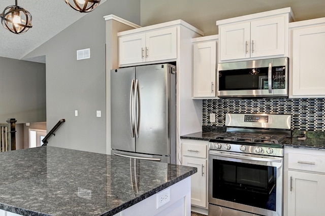 38391 Hunters Ridge Trl, North Branch, MN 55056 - kitchen featuring stainless steel appliances, lofted ceiling, backsplash, white cabinetry, and pendant lighting