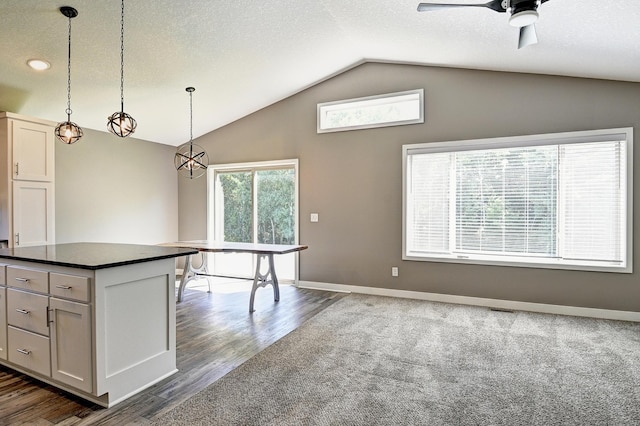 38391 Hunters Ridge Trl, North Branch, MN 55056 - kitchen with dark countertops, vaulted ceiling, ceiling fan, pendant lighting, and dark wood finished floors
