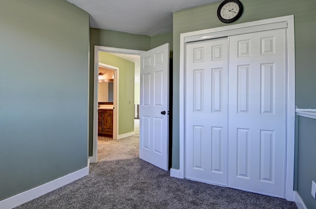 38391 Hunters Ridge Trl, North Branch, MN 55056 - unfurnished bedroom with dark colored carpet and a closet
