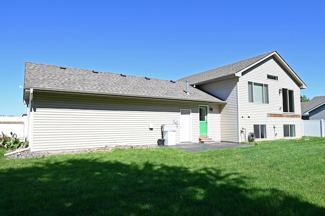 38391 Hunters Ridge Trl, North Branch, MN 55056 - rear view of house with a lawn and a shingled roof