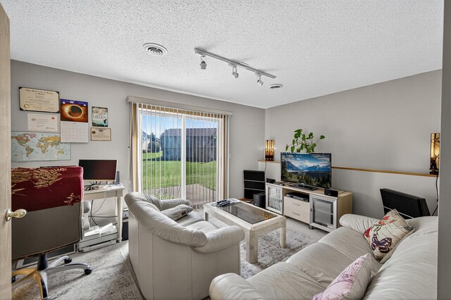 7217 92nd Trl N, Brooklyn Park, MN 55445 - living area featuring track lighting, a textured ceiling, light carpet, and a desk