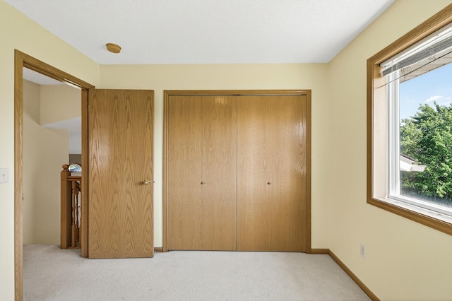 7217 92nd Trl N, Brooklyn Park, MN 55445 - unfurnished bedroom featuring light carpet and a closet