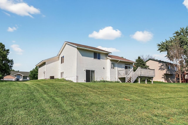 7217 92nd Trl N, Brooklyn Park, MN 55445 - rear view of house with a deck, a lawn, and stairs
