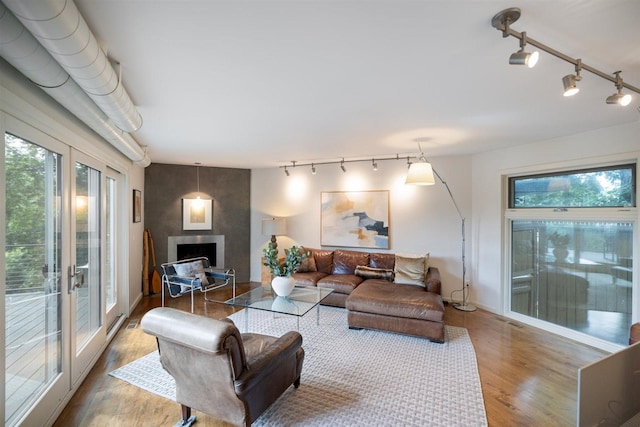 1921 Ewing Ave S, Minneapolis, MN 55416 - living area featuring rail lighting, wood finished floors, and a fireplace