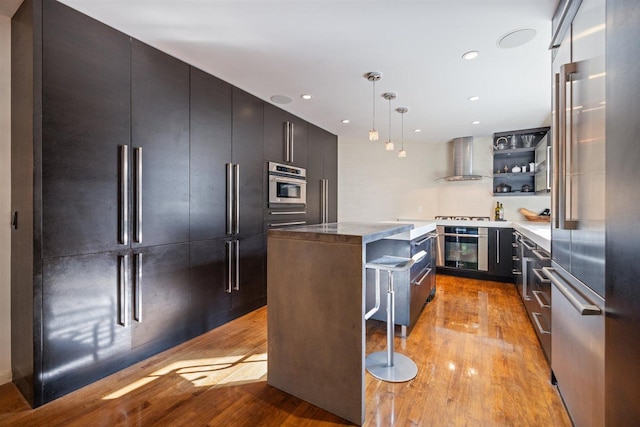 1921 Ewing Ave S, Minneapolis, MN 55416 - kitchen featuring wall chimney exhaust hood, appliances with stainless steel finishes, light wood-style flooring, open shelves, and recessed lighting