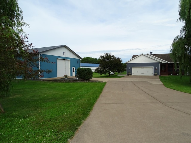 568 Midway Rd, Menomonie, WI 54751 - view of green lawn with a garage and concrete driveway