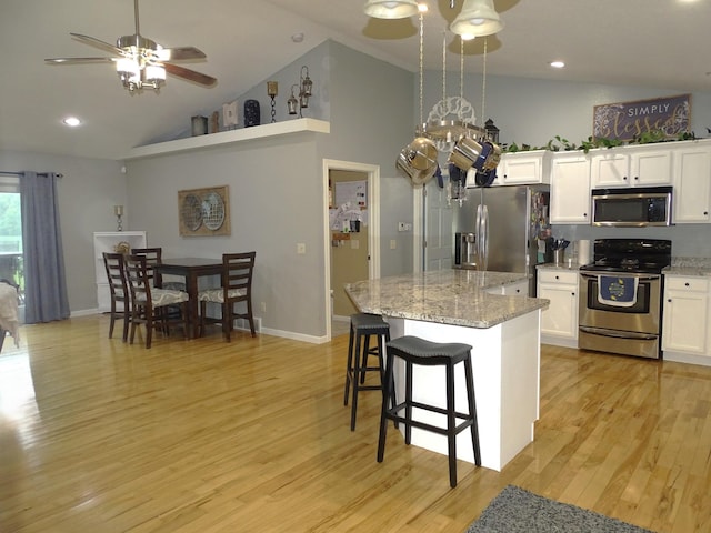 568 Midway Rd, Menomonie, WI 54751 - kitchen with appliances with stainless steel finishes, ceiling fan, a center island, light wood-style flooring, and white cabinetry