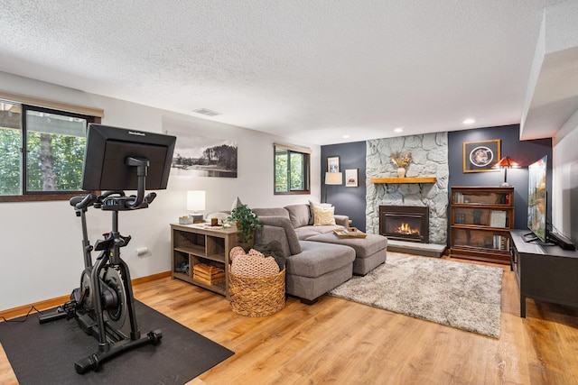 4463 Arden View Ct, Arden Hills, MN 55112 - living room featuring wood finished floors, a textured ceiling, a fireplace, and recessed lighting