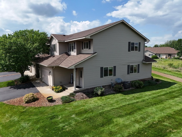 519 Graceview Loop, Saint Joseph, MN 56374 - traditional-style house featuring a shingled roof, a front lawn, asphalt driveway, and an attached garage