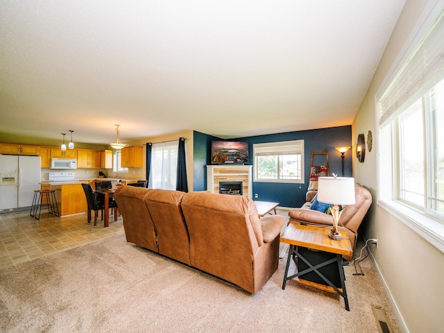 519 Graceview Loop, Saint Joseph, MN 56374 - living room with a tiled fireplace, light carpet, and light tile patterned floors