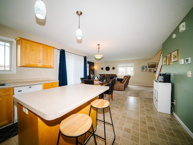 519 Graceview Loop, Saint Joseph, MN 56374 - kitchen featuring white dishwasher, a kitchen island, light countertops, open floor plan, and a breakfast bar