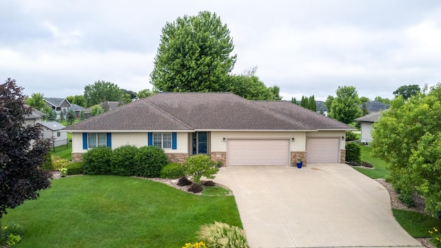 1100 27th St SW, Austin, MN 55912 - ranch-style home featuring an attached garage, concrete driveway, a front lawn, and stone siding