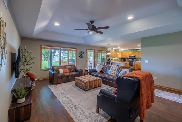1100 27th St SW, Austin, MN 55912 - living room featuring a tray ceiling, dark wood finished floors, recessed lighting, and ceiling fan