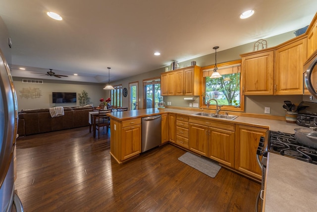 1100 27th St SW, Austin, MN 55912 - kitchen featuring appliances with stainless steel finishes, open floor plan, dark wood finished floors, light countertops, and recessed lighting