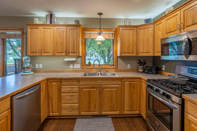 1100 27th St SW, Austin, MN 55912 - kitchen featuring stainless steel appliances, hanging light fixtures, light countertops, and dark wood-style flooring
