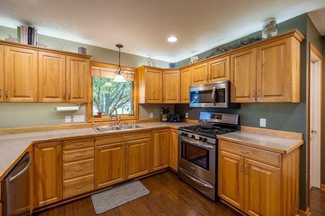 1100 27th St SW, Austin, MN 55912 - kitchen featuring appliances with stainless steel finishes, dark wood-style floors, light countertops, hanging light fixtures, and recessed lighting
