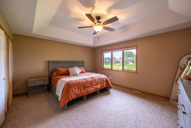 1100 27th St SW, Austin, MN 55912 - bedroom with a tray ceiling, light carpet, and ceiling fan
