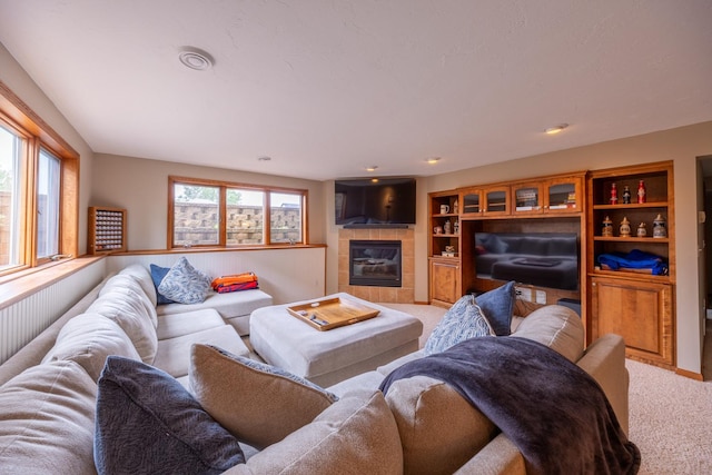 1100 27th St SW, Austin, MN 55912 - carpeted living room featuring healthy amount of natural light and a tile fireplace