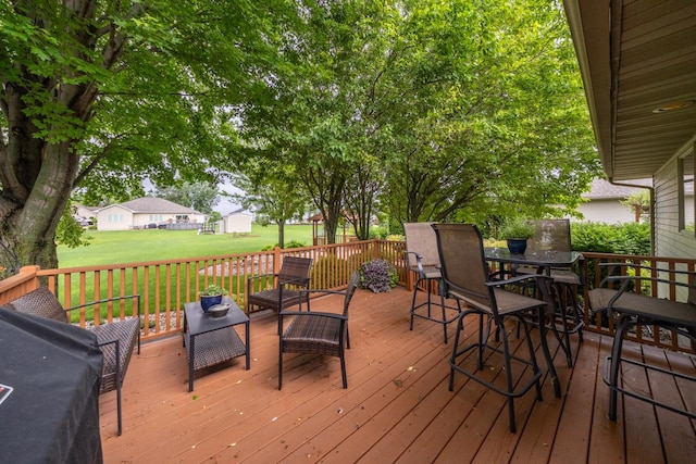 1100 27th St SW, Austin, MN 55912 - deck with a yard, outdoor dining space, a storage shed, and an outdoor hangout area