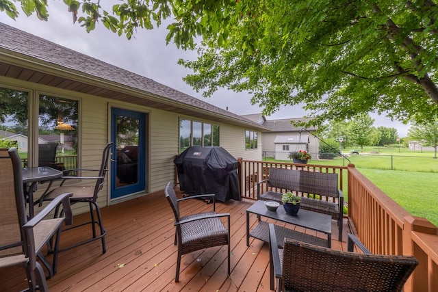 1100 27th St SW, Austin, MN 55912 - wooden deck with area for grilling, a fenced backyard, and an outdoor hangout area