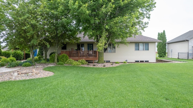 1100 27th St SW, Austin, MN 55912 - view of front of property featuring a front lawn, a deck, and a shingled roof
