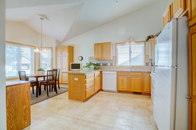 12707 Ivywood St NW, Coon Rapids, MN 55448 - kitchen with white appliances, a peninsula, a chandelier, decorative light fixtures, and light countertops