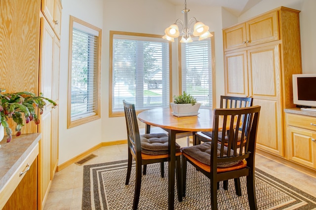 12707 Ivywood St NW, Coon Rapids, MN 55448 - dining room with a chandelier, light tile patterned floors, and healthy amount of natural light