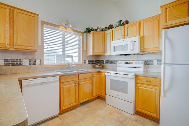 12707 Ivywood St NW, Coon Rapids, MN 55448 - kitchen with white appliances, light countertops, backsplash, vaulted ceiling, and light brown cabinets