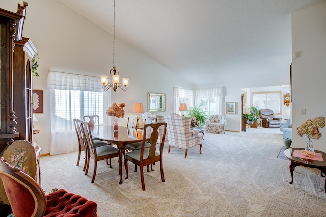 12707 Ivywood St NW, Coon Rapids, MN 55448 - dining area featuring light colored carpet, a chandelier, healthy amount of natural light, and high vaulted ceiling