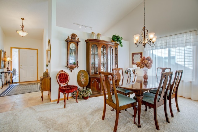12707 Ivywood St NW, Coon Rapids, MN 55448 - dining area with a chandelier, vaulted ceiling, track lighting, and carpet