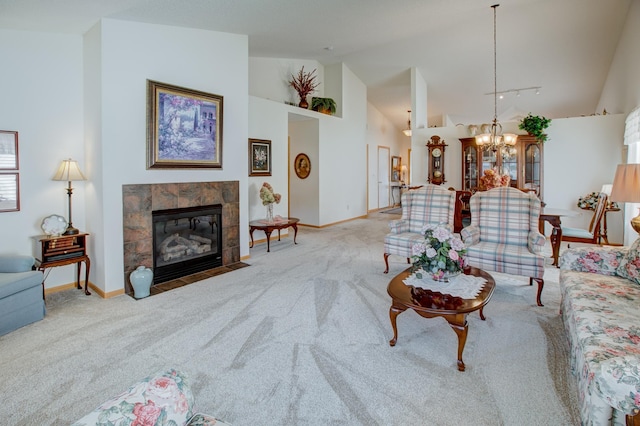 12707 Ivywood St NW, Coon Rapids, MN 55448 - living area with carpet flooring, high vaulted ceiling, a tiled fireplace, and a chandelier
