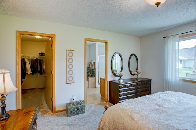 12707 Ivywood St NW, Coon Rapids, MN 55448 - bedroom featuring a walk in closet, light carpet, a textured ceiling, and a closet