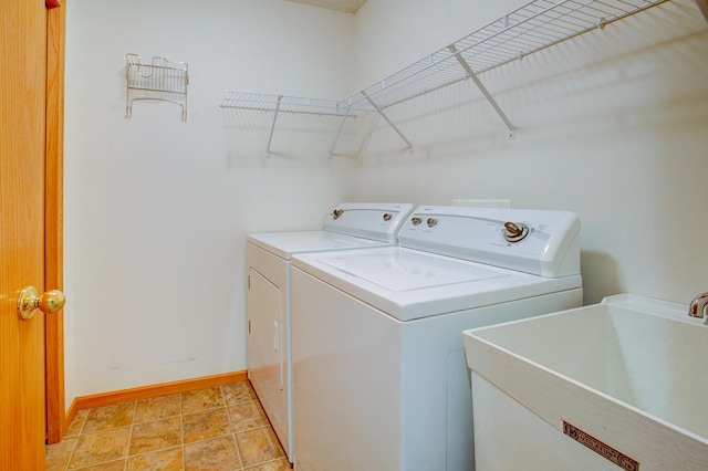 12707 Ivywood St NW, Coon Rapids, MN 55448 - laundry room with washer and clothes dryer and baseboards