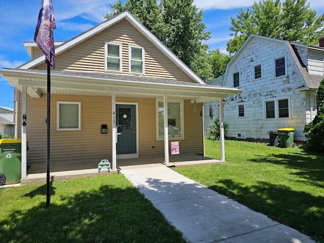 411 Main St, Pipestone, MN 56164 - view of front of home with covered porch and a front lawn