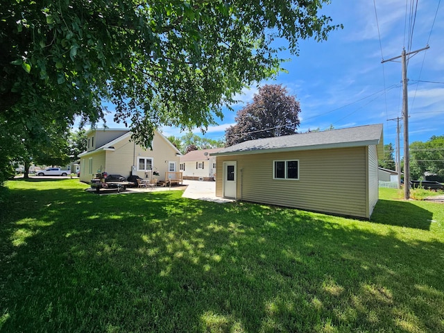 411 Main St, Pipestone, MN 56164 - back of house featuring a patio and a yard