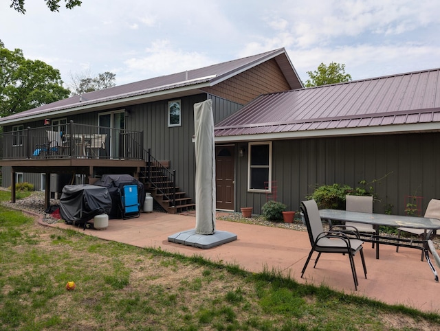 19963 County 18, Henrietta Twp, MN 56470 - rear view of property with a patio, a metal roof, a deck, stairway, and outdoor dining area