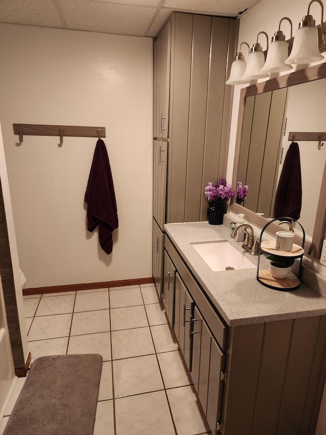 19963 County 18, Henrietta Twp, MN 56470 - bathroom featuring vanity, tile patterned flooring, and a drop ceiling