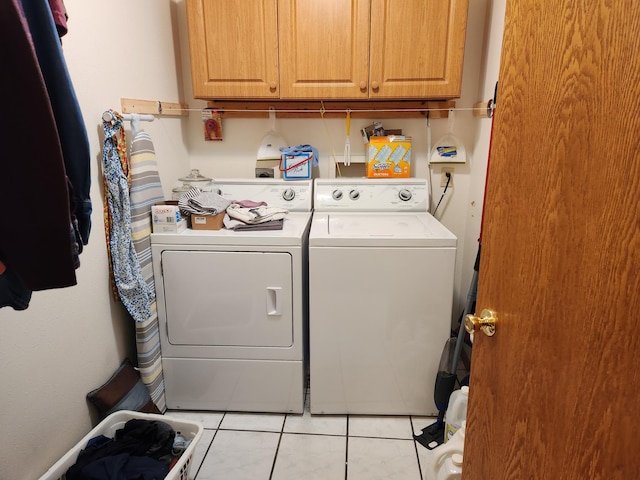 19963 County 18, Henrietta Twp, MN 56470 - washroom featuring separate washer and dryer, cabinet space, and light tile patterned floors