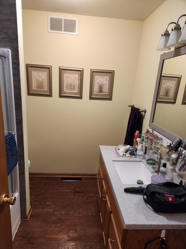 19963 County 18, Henrietta Twp, MN 56470 - half bath with vanity and wood finished floors
