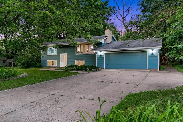 801 Corens Dr, Minnetonka, MN 55305 - bi-level home with a chimney, a front lawn, an attached garage, and driveway