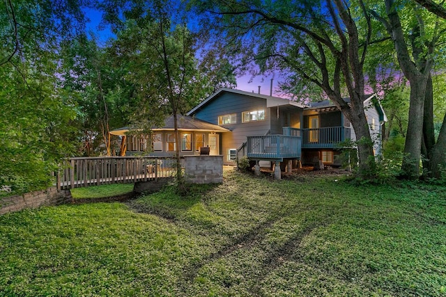 801 Corens Dr, Minnetonka, MN 55305 - back of property at dusk featuring a yard and a wooden deck