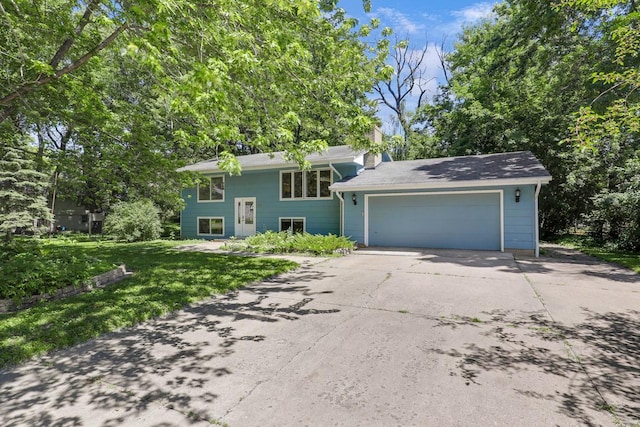 801 Corens Dr, Minnetonka, MN 55305 - view of front facade with concrete driveway, an attached garage, a chimney, and a front yard