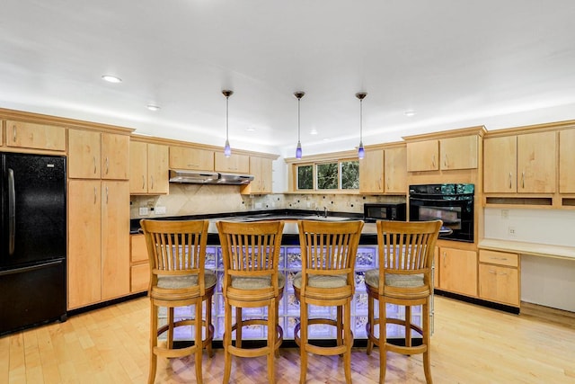 801 Corens Dr, Minnetonka, MN 55305 - kitchen featuring black appliances, light brown cabinetry, under cabinet range hood, light wood finished floors, and recessed lighting
