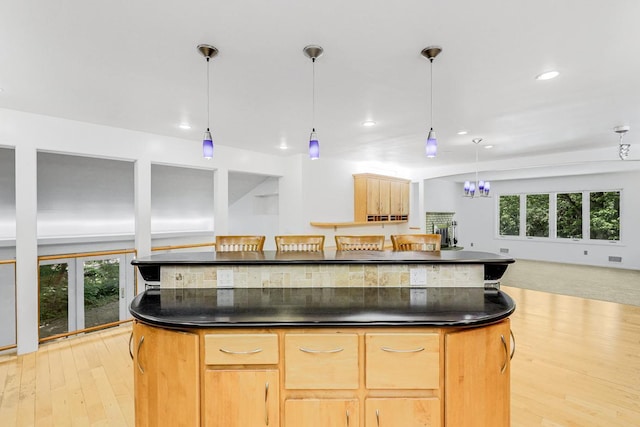 801 Corens Dr, Minnetonka, MN 55305 - kitchen featuring dark countertops, healthy amount of natural light, a kitchen island, and recessed lighting