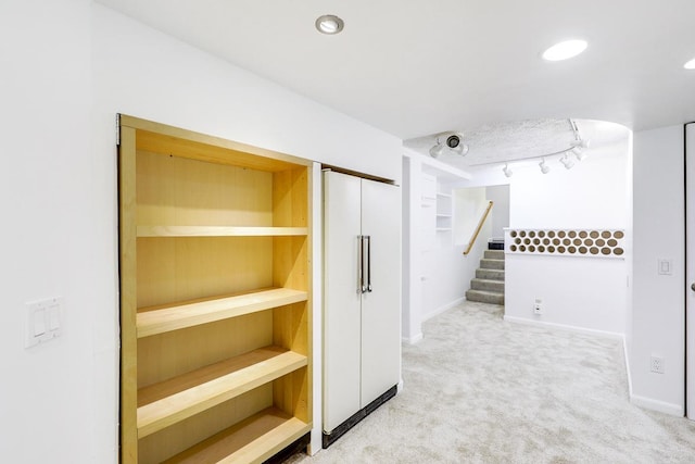 801 Corens Dr, Minnetonka, MN 55305 - corridor with light carpet, stairs, and rail lighting