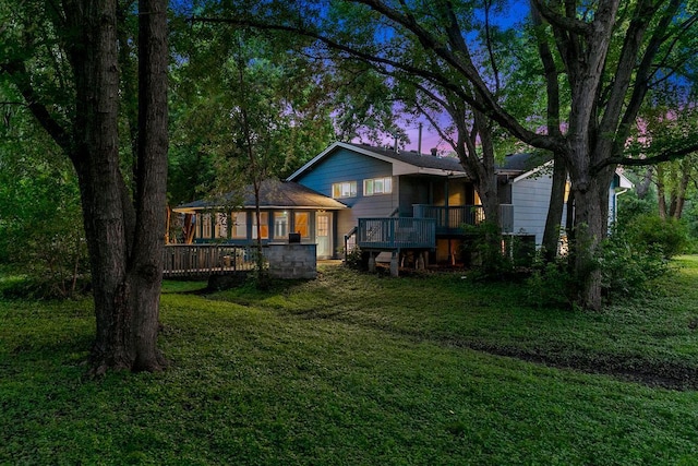 801 Corens Dr, Minnetonka, MN 55305 - back of property at dusk with a lawn and a wooden deck