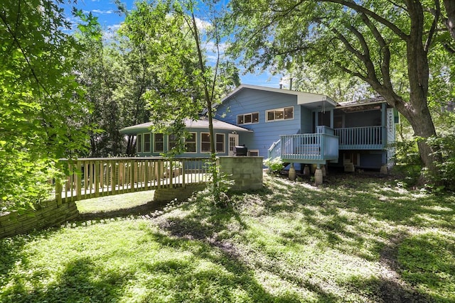 801 Corens Dr, Minnetonka, MN 55305 - back of property featuring a deck, a sunroom, and a lawn