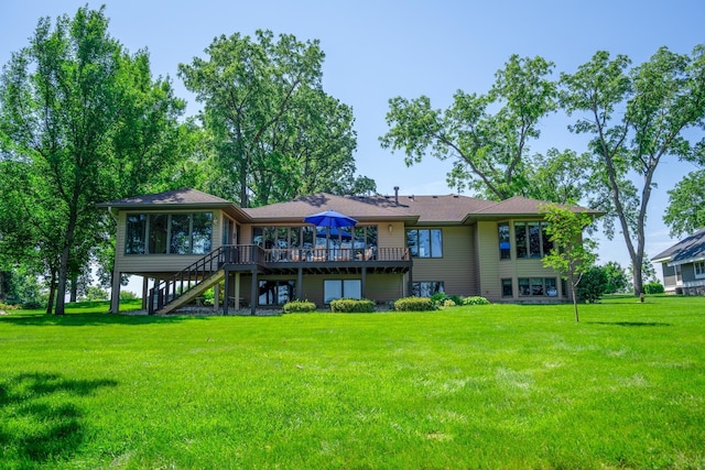 870 Andrew Dr NE, Lake Andrew Twp, MN 56273 - back of house with stairway, a deck, a lawn, and a sunroom
