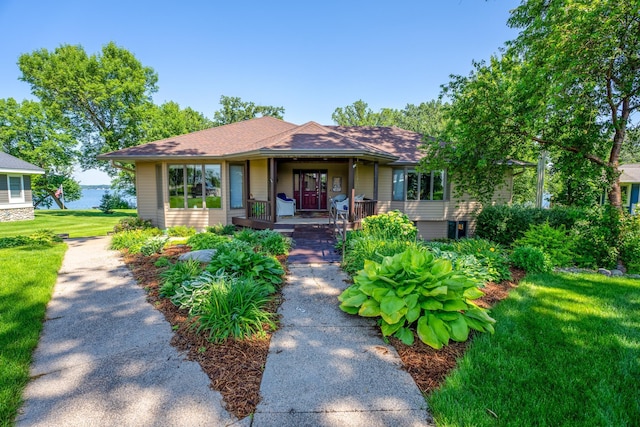 870 Andrew Dr NE, Lake Andrew Twp, MN 56273 - view of front of home with a porch, a front lawn, and roof with shingles