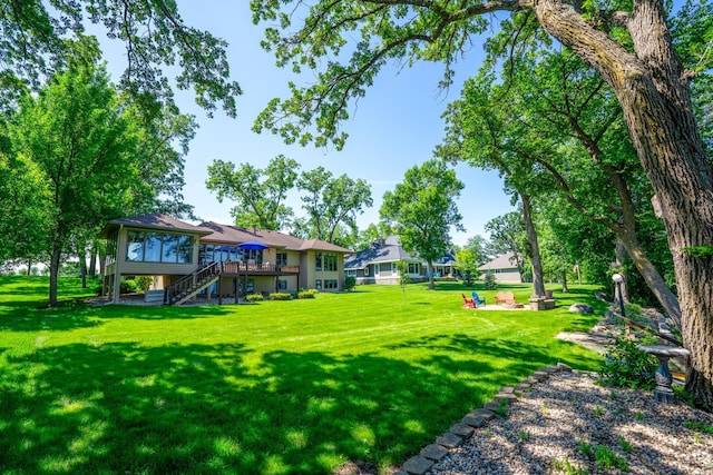 870 Andrew Dr NE, Lake Andrew Twp, MN 56273 - view of green lawn with stairway and a deck